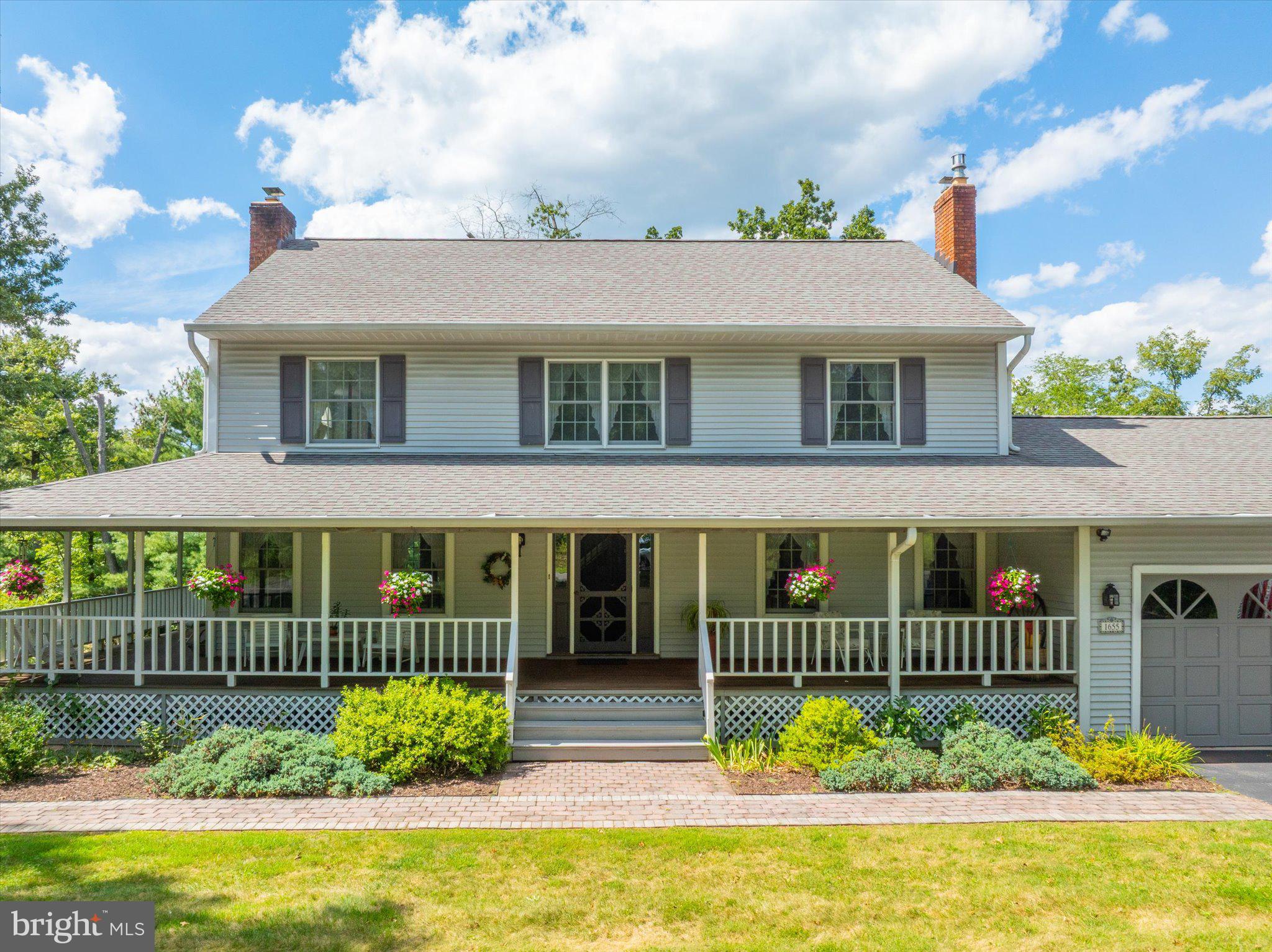 1655 Kriebel Mill Road Collegeville, PA 19426 - Photo 2 of 57 a view of a white house with a small yard and plants