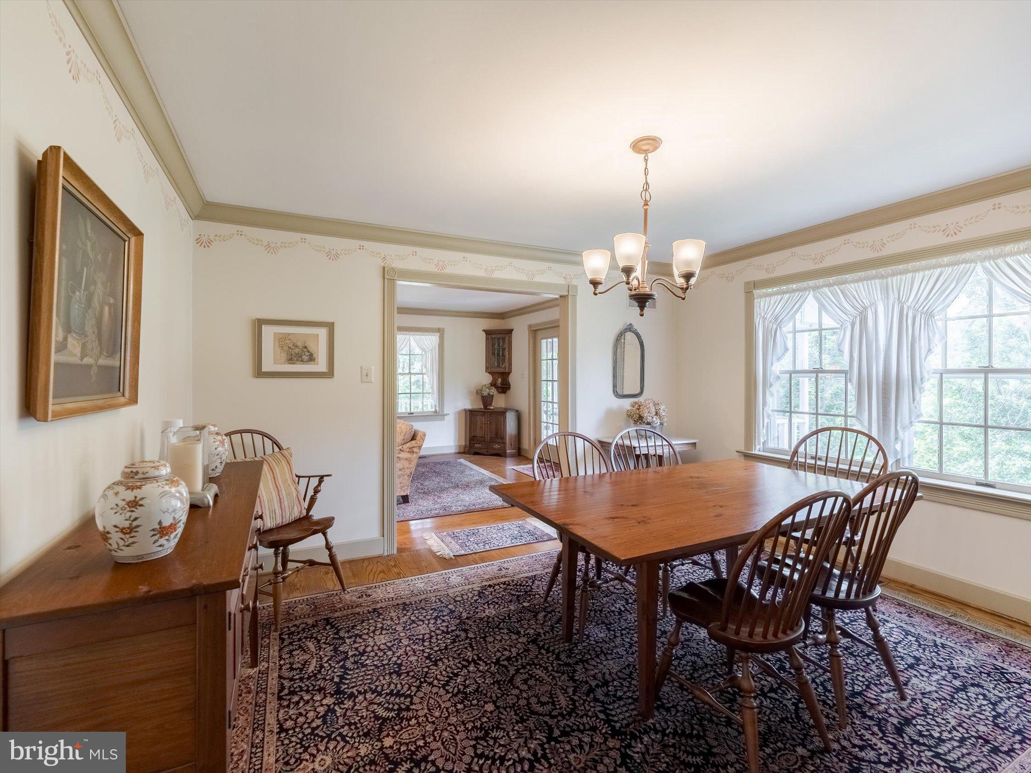 1655 Kriebel Mill Road Collegeville, PA 19426 - Photo 24 of 57 a dining room with furniture a chandelier and wooden floor