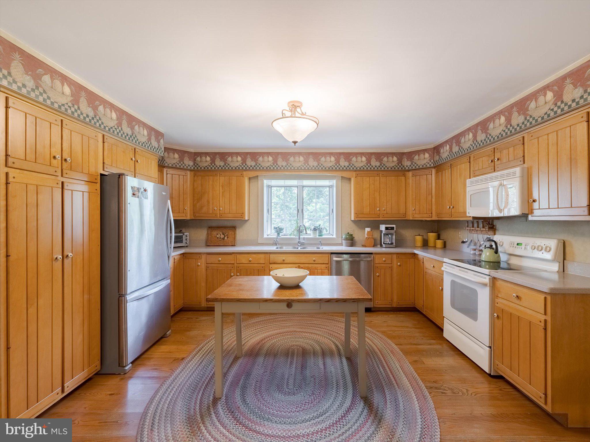 1655 Kriebel Mill Road Collegeville, PA 19426 - Photo 25 of 57 a large kitchen with a large window a sink and stainless steel appliances