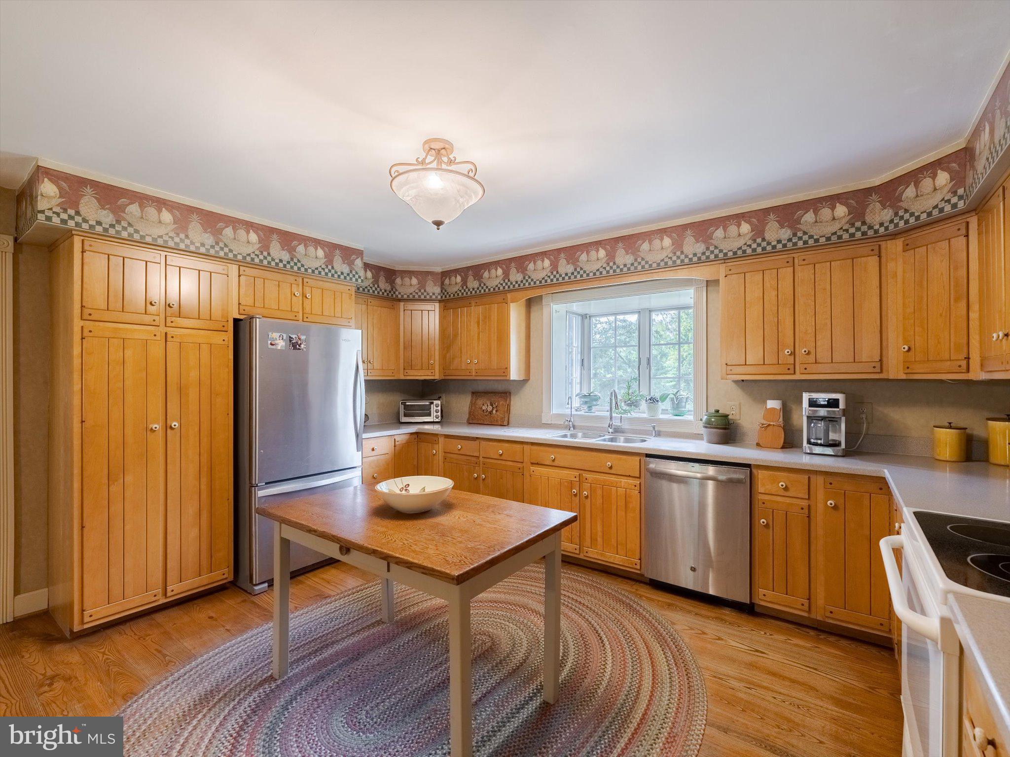 1655 Kriebel Mill Road Collegeville, PA 19426 - Photo 27 of 57 a kitchen with stainless steel appliances granite countertop a kitchen island hardwood floor sink stove and granite counter top