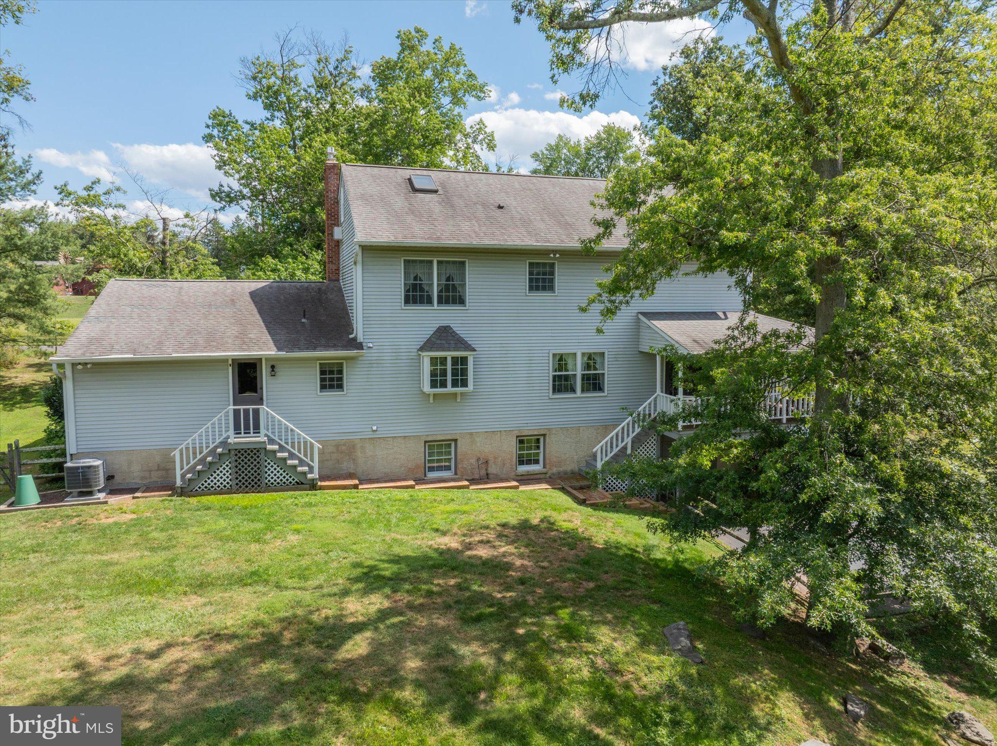 1655 Kriebel Mill Road Collegeville, PA 19426 - Photo 54 of 57 a view of a house with a yard potted plants and a table