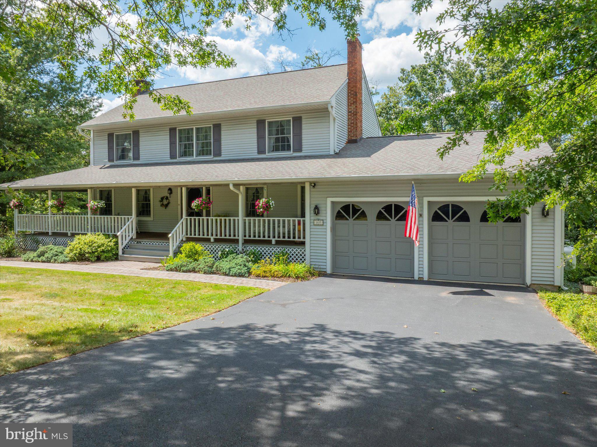 1655 Kriebel Mill Road Collegeville, PA 19426 - Photo 6 of 57 a front view of a house with a yard and potted plants