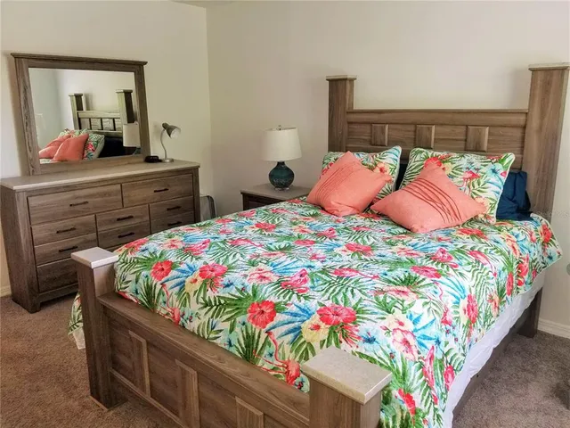 a bedroom with a bed and a dresser in it