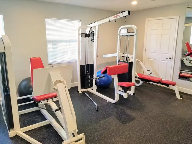 a living room with lots of furniture and a book shelf
