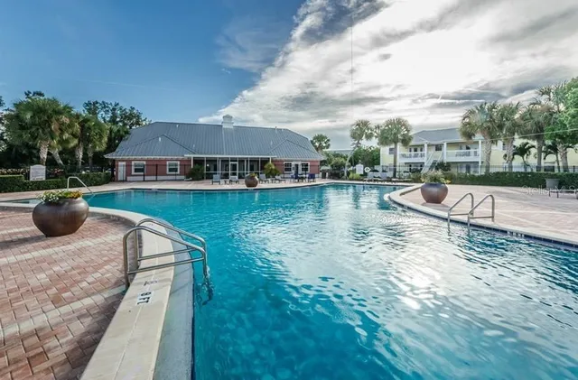 a view of a street with a building and trees in the background