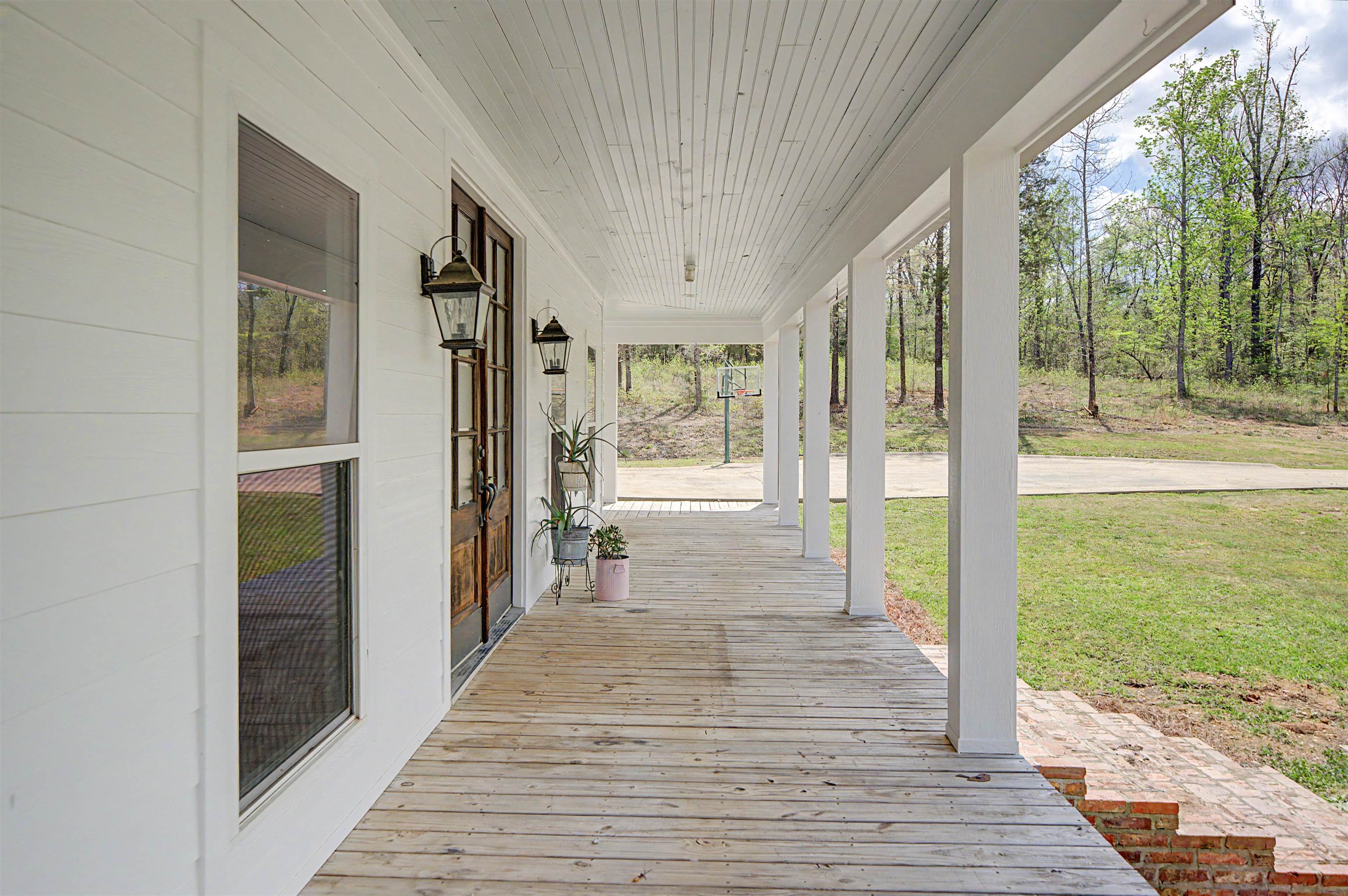 300 Grace Thomas Road Michie, TN 38357 - Photo 19 of 26 Wooden porch with a lawn