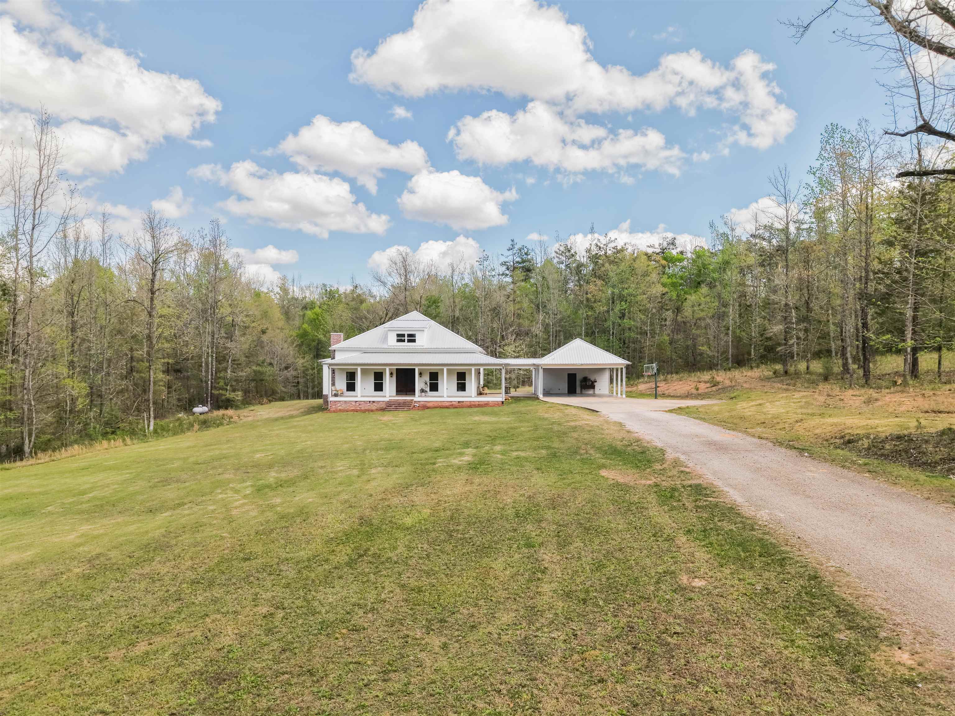 300 Grace Thomas Road Michie, TN 38357 - Photo 7 of 26 View of front facade with driveway, a front yard, covered porch, and an attached carport