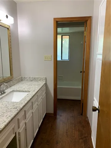 a bathroom with a bathtub toilet and window