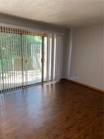 a view of wooden floor and windows in a room