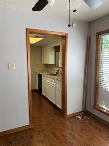 an empty room with a kitchen and a window