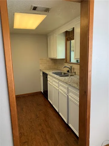a kitchen with a sink and cabinets