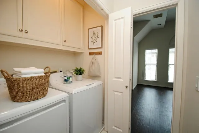 a spacious bedroom with a bed a couch and a window