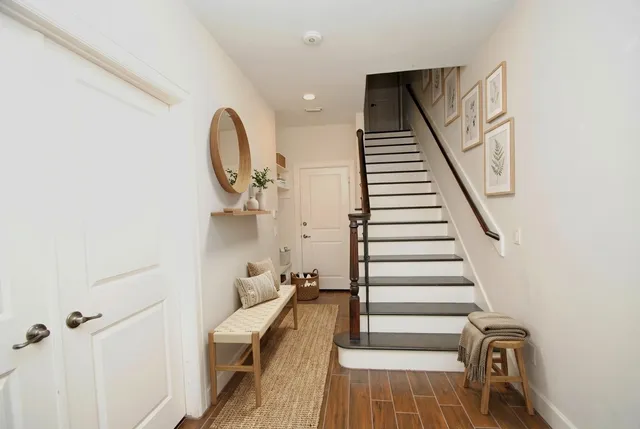 a view of entryway and hall with wooden floor