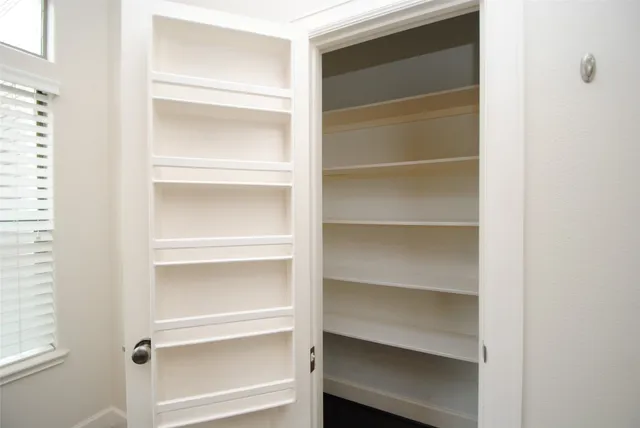 a kitchen with stainless steel appliances granite countertop a sink cabinets and wooden floor