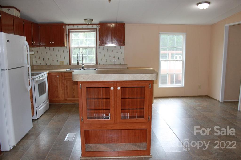 339 Dewitt Owens Road Rutherfordton, NC 28139 - Photo 22 of 48 a kitchen with stainless steel appliances granite countertop a stove a refrigerator and a cabinets