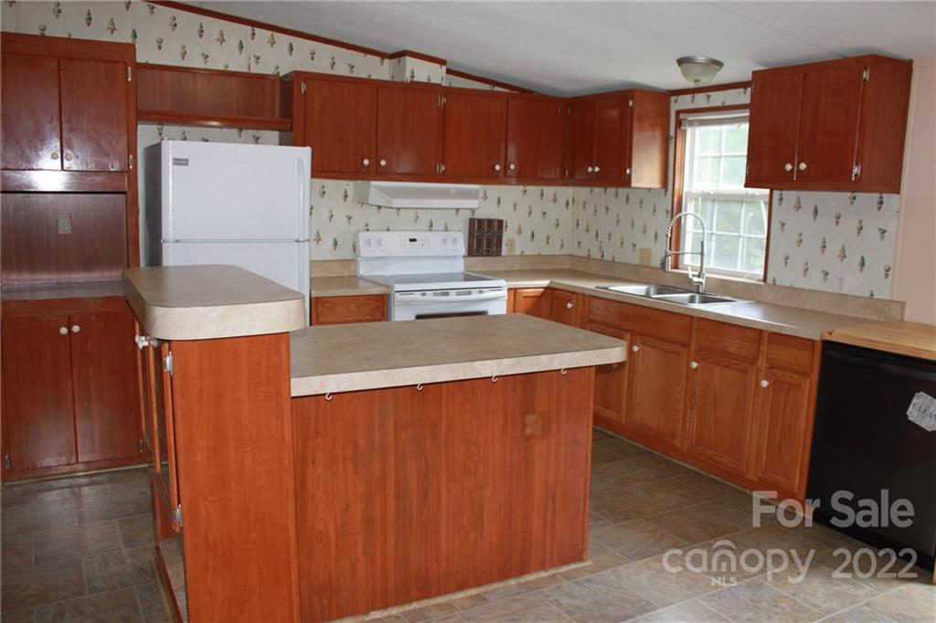 339 Dewitt Owens Road Rutherfordton, NC 28139 - Photo 23 of 48 a kitchen with a sink a stove and a refrigerator