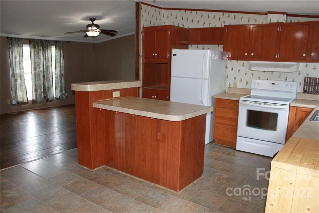 339 Dewitt Owens Road Rutherfordton, NC 28139 - Photo 24 of 48 a kitchen with stainless steel appliances granite countertop a sink a stove and a refrigerator