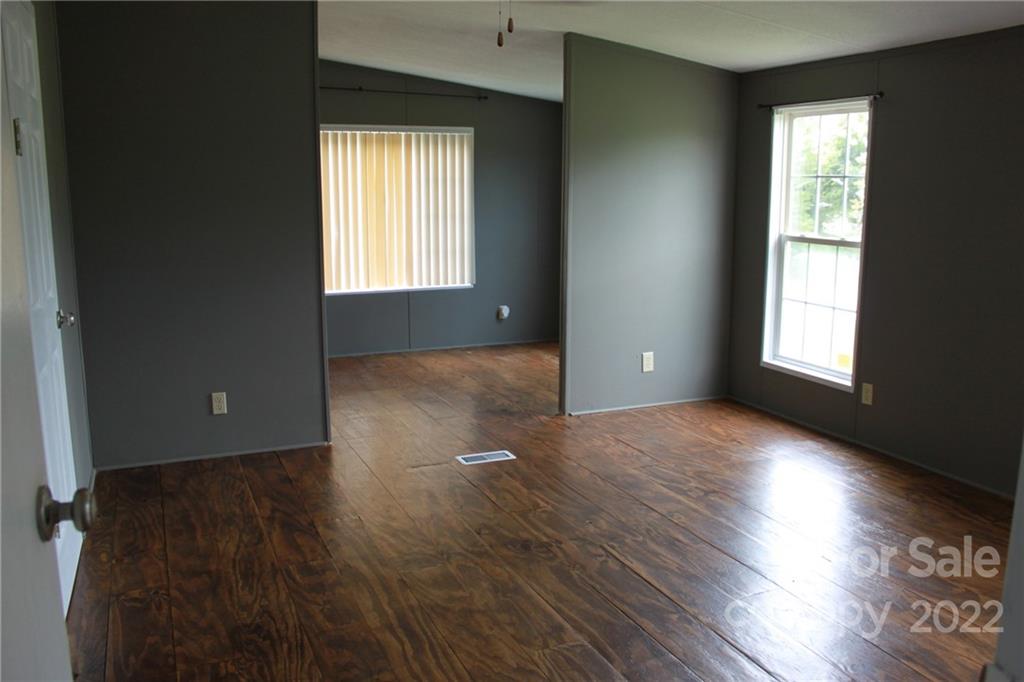 339 Dewitt Owens Road Rutherfordton, NC 28139 - Photo 28 of 48 an empty room with wooden floor and windows