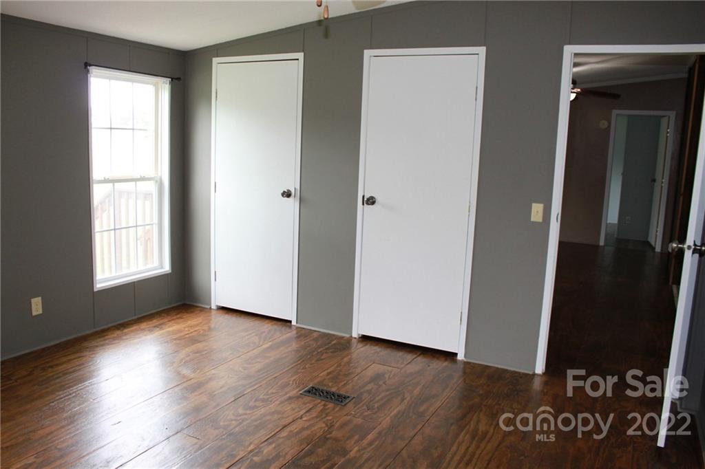 339 Dewitt Owens Road Rutherfordton, NC 28139 - Photo 29 of 48 an empty room with wooden floor and windows