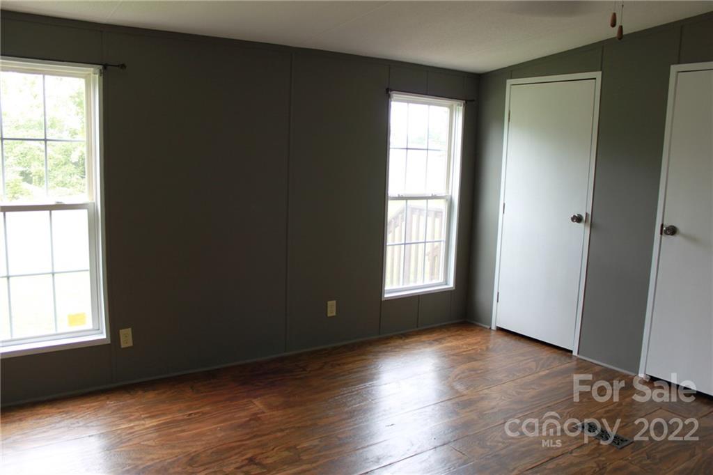 339 Dewitt Owens Road Rutherfordton, NC 28139 - Photo 30 of 48 an empty room with wooden floor and windows