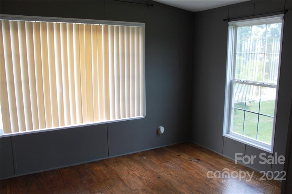 339 Dewitt Owens Road Rutherfordton, NC 28139 - Photo 31 of 48 a view of an empty room with wooden floor and a window