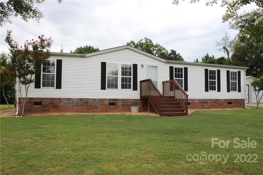 339 Dewitt Owens Road Rutherfordton, NC 28139 - Photo 8 of 48 a front view of a house with a garden and yard