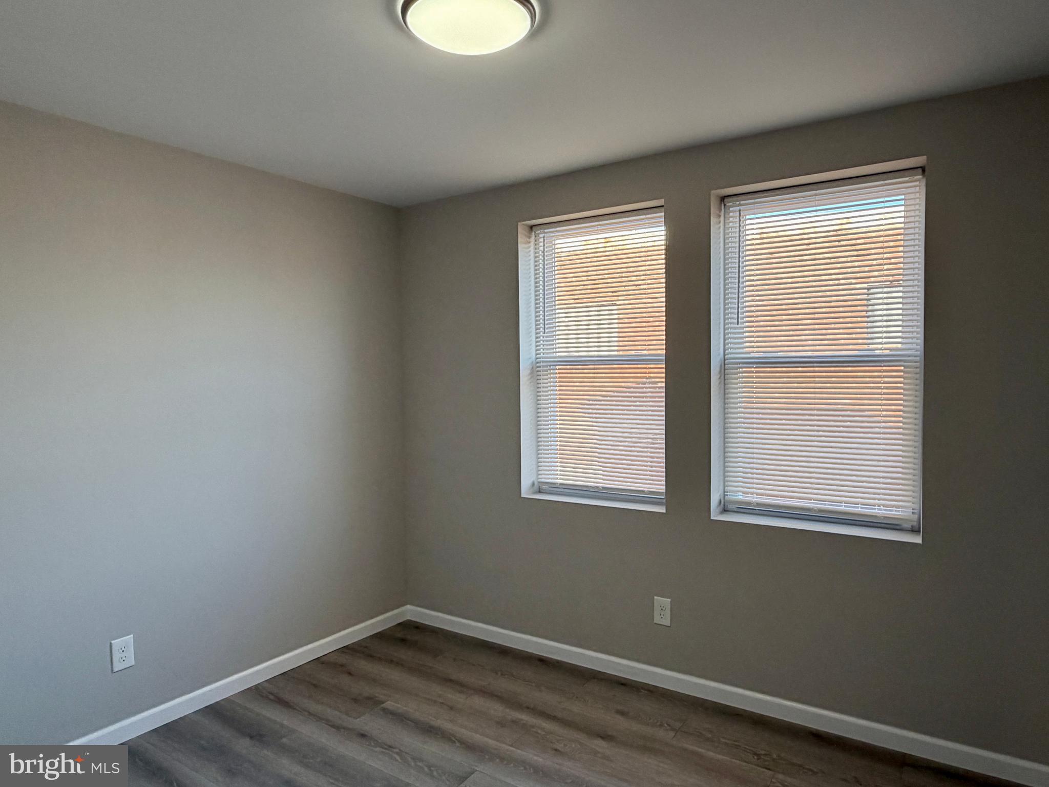 1727 Dallas Street, Unit 1 Philadelphia, PA 19126 - Photo 11 of 25 a room that has a window and wooden floor