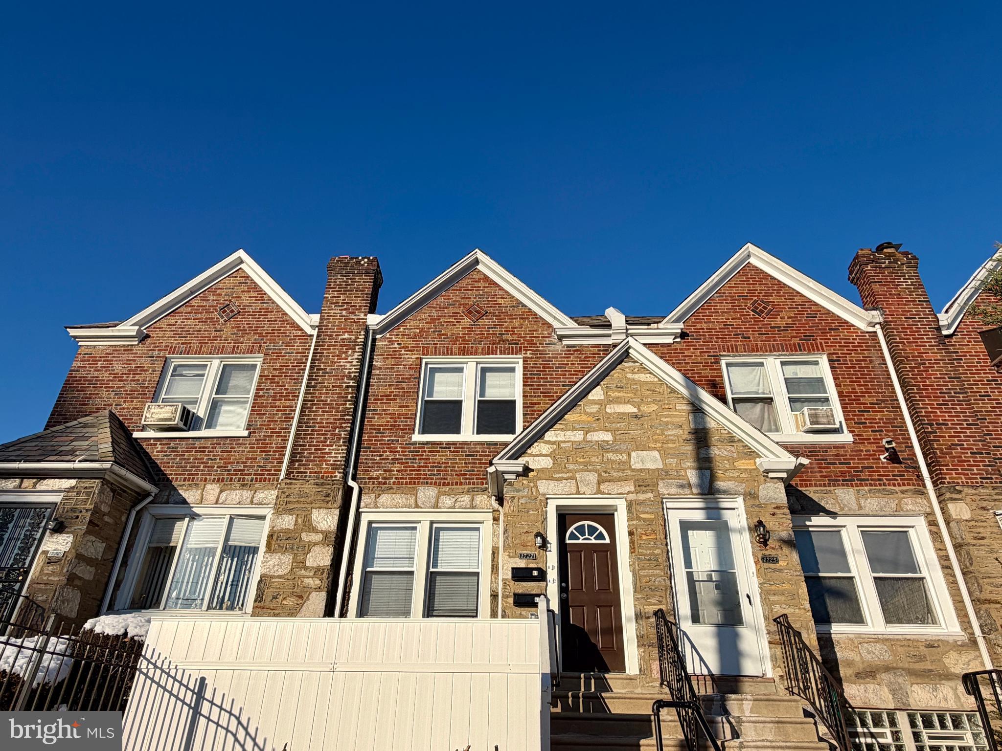 1727 Dallas Street, Unit 1 Philadelphia, PA 19126 - Photo 2 of 25 a view of a brick house with many windows