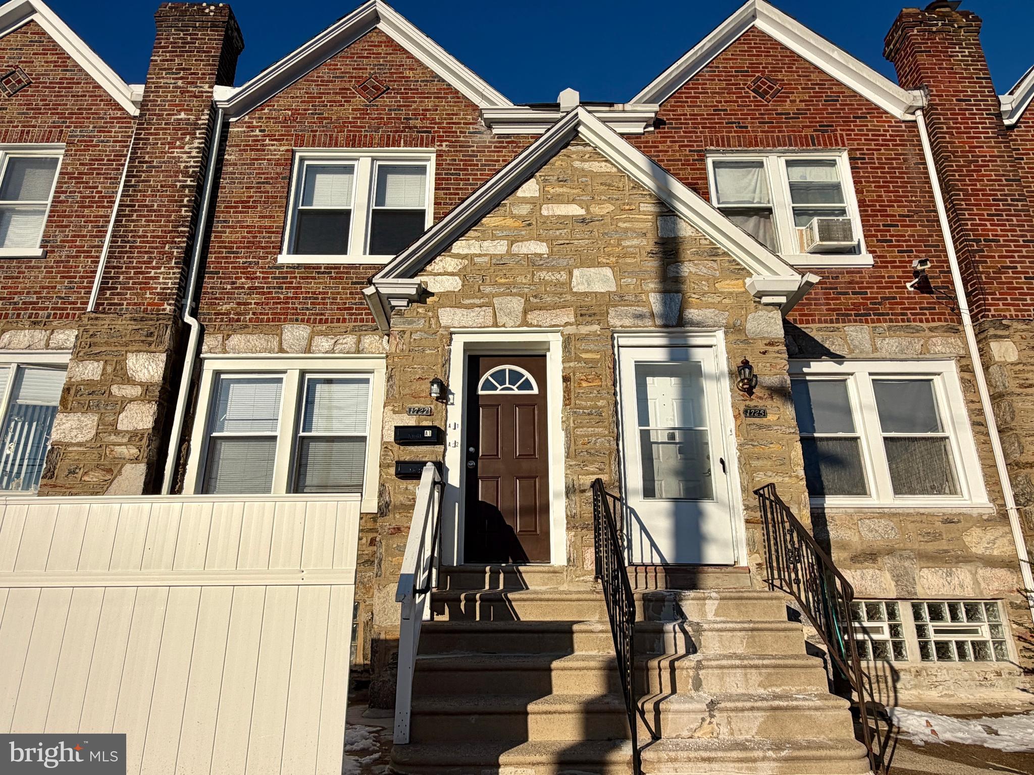 1727 Dallas Street, Unit 1 Philadelphia, PA 19126 - Photo 4 of 25 a view of a brick house with large windows