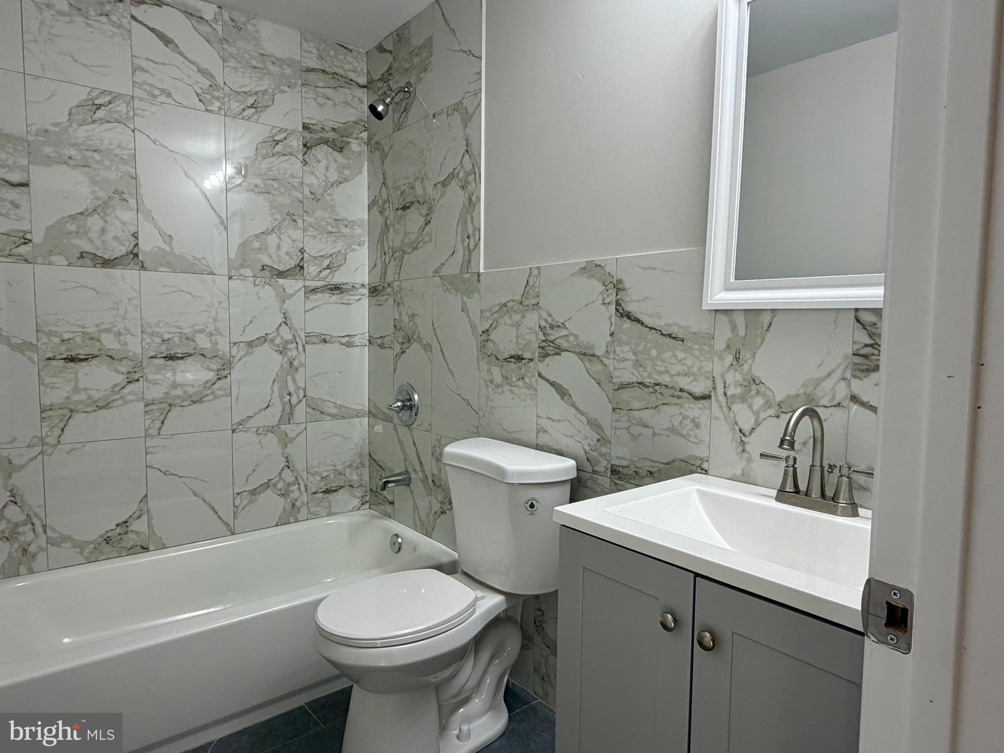 1727 Dallas Street, Unit 1 Philadelphia, PA 19126 - Photo 7 of 25 a bathroom with a sink a toilet and shower