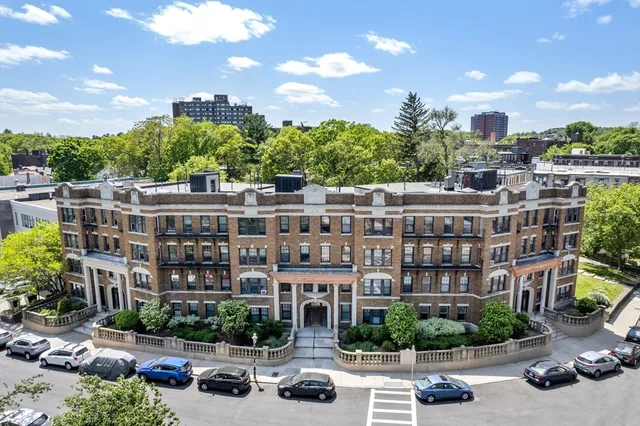 a view of a building with cars park