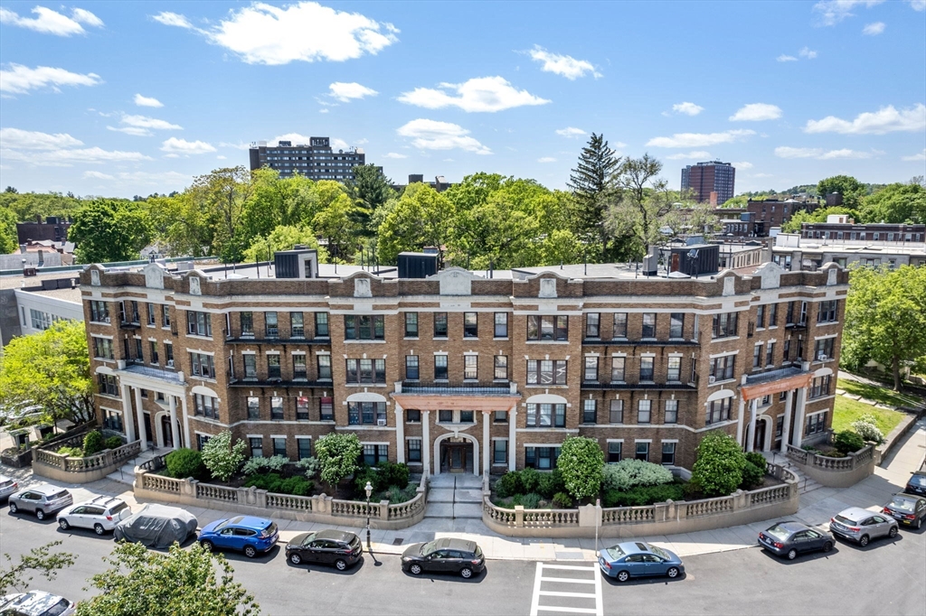 a view of a building with cars park