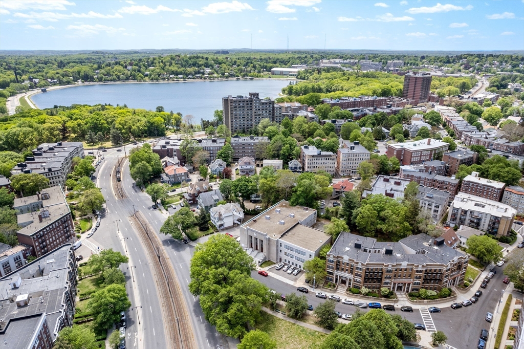 24 Sidlaw Road, Unit 12 Boston, MA 02135 - Photo 2 of 15 an aerial view of a city with lots of residential buildings ocean and mountain view in back