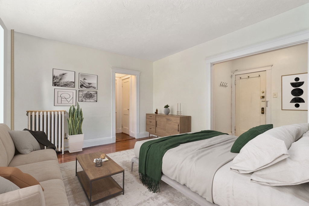 24 Sidlaw Road, Unit 12 Boston, MA 02135 - Photo 4 of 15 a bedroom with a bed and a couch