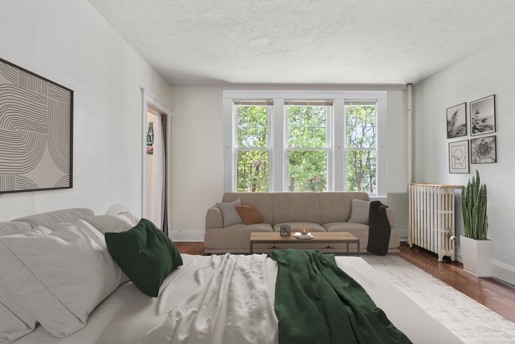 24 Sidlaw Road, Unit 12 Boston, MA 02135 - Photo 5 of 15 a bed sitting in a bedroom next to a window