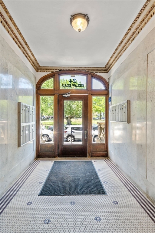 24 Sidlaw Road, Unit 12 Boston, MA 02135 - Photo 9 of 15 a bedroom with a large bed and a large window