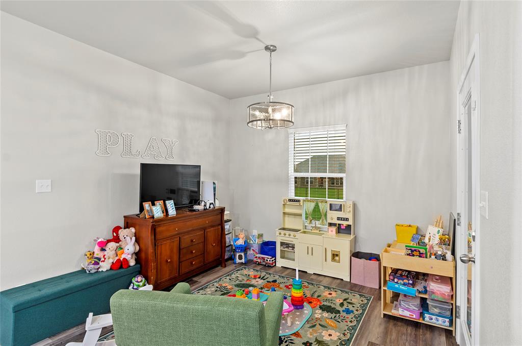 141 Walnut Street Paradise, TX 76073 - Photo 14 of 23 Rec room with wood finished floors and hanging lights