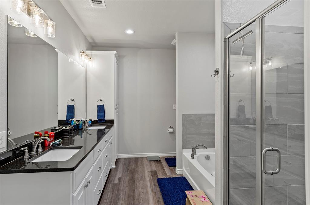 141 Walnut Street Paradise, TX 76073 - Photo 16 of 23 Full bath with double vanity, a bath, dark wood-style floors, a stall shower, and recessed lighting