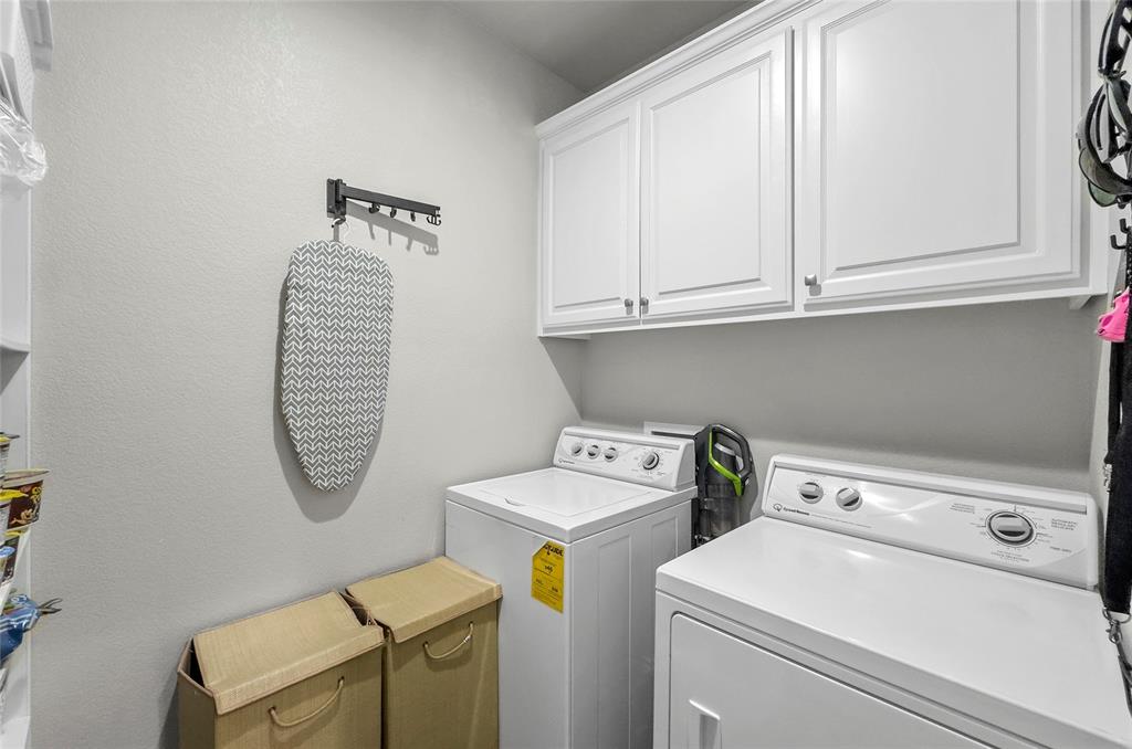 141 Walnut Street Paradise, TX 76073 - Photo 19 of 23 Laundry area featuring washer and dryer and cabinet space
