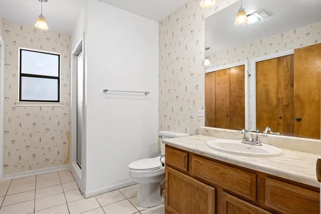 an empty room with wooden floor and entrance