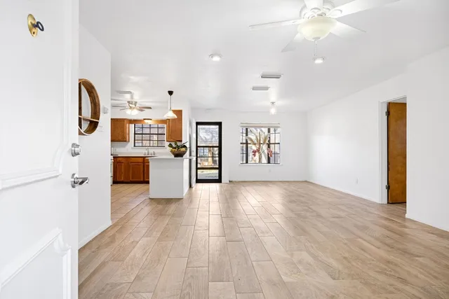 a view of a kitchen with kitchen island wooden floor and window