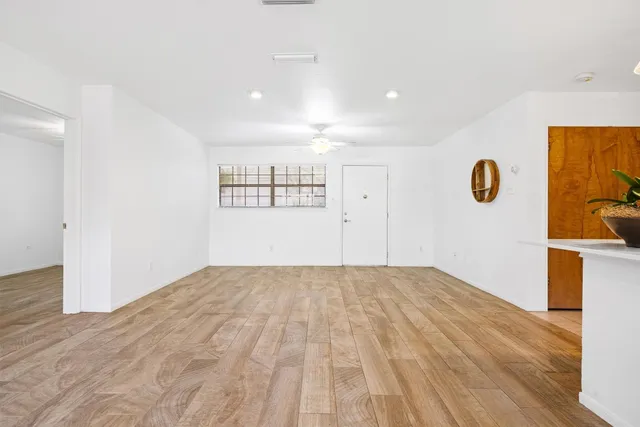 a view of empty room with wooden floor
