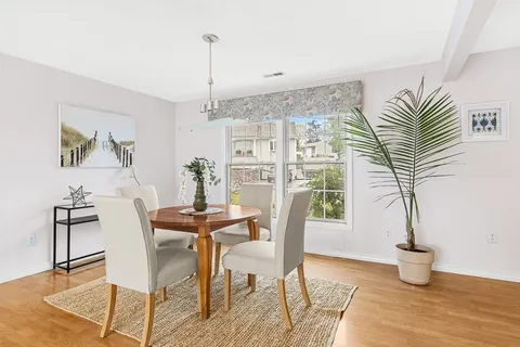 a view of a dining room with furniture window and wooden floor