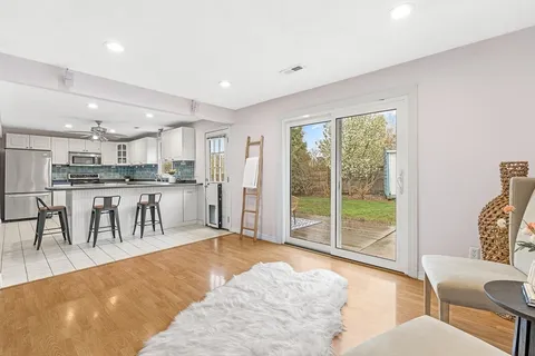 a kitchen with stainless steel appliances kitchen island granite countertop a refrigerator and a sink