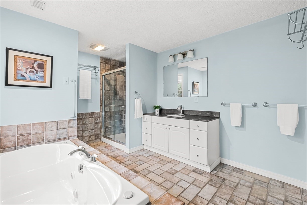 3 Theresa Road Stoneham, MA 02180 - Photo 22 of 42 a bathroom with a bathtub sink and mirror