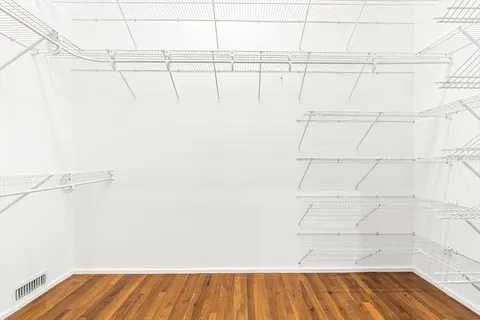 a view of a room with wooden floor