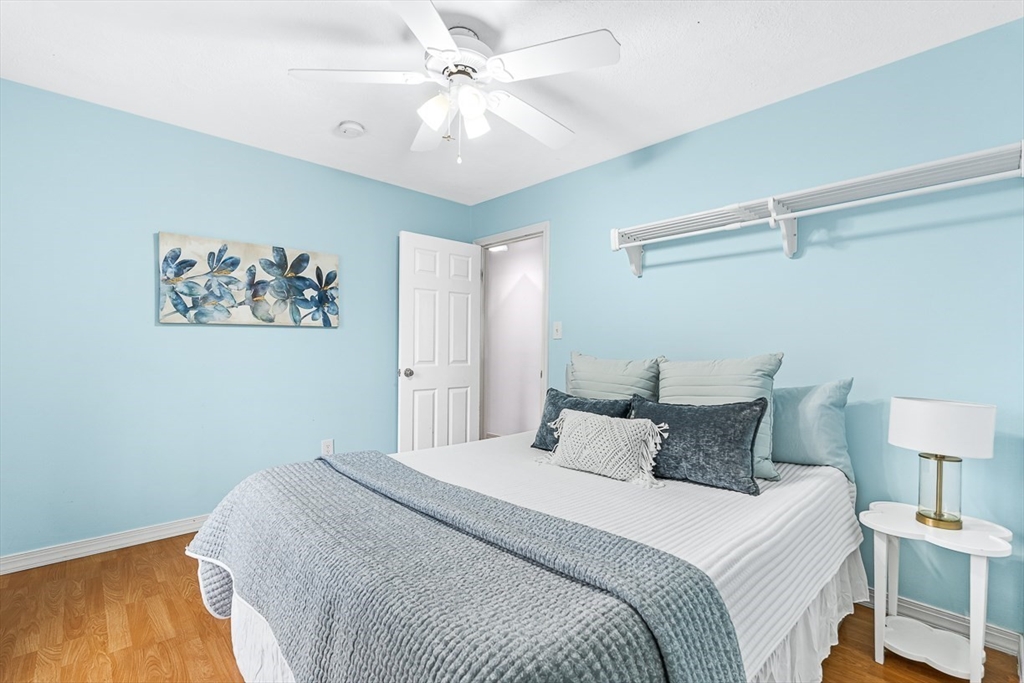 3 Theresa Road Stoneham, MA 02180 - Photo 26 of 42 a bedroom with a large bed and a chandelier
