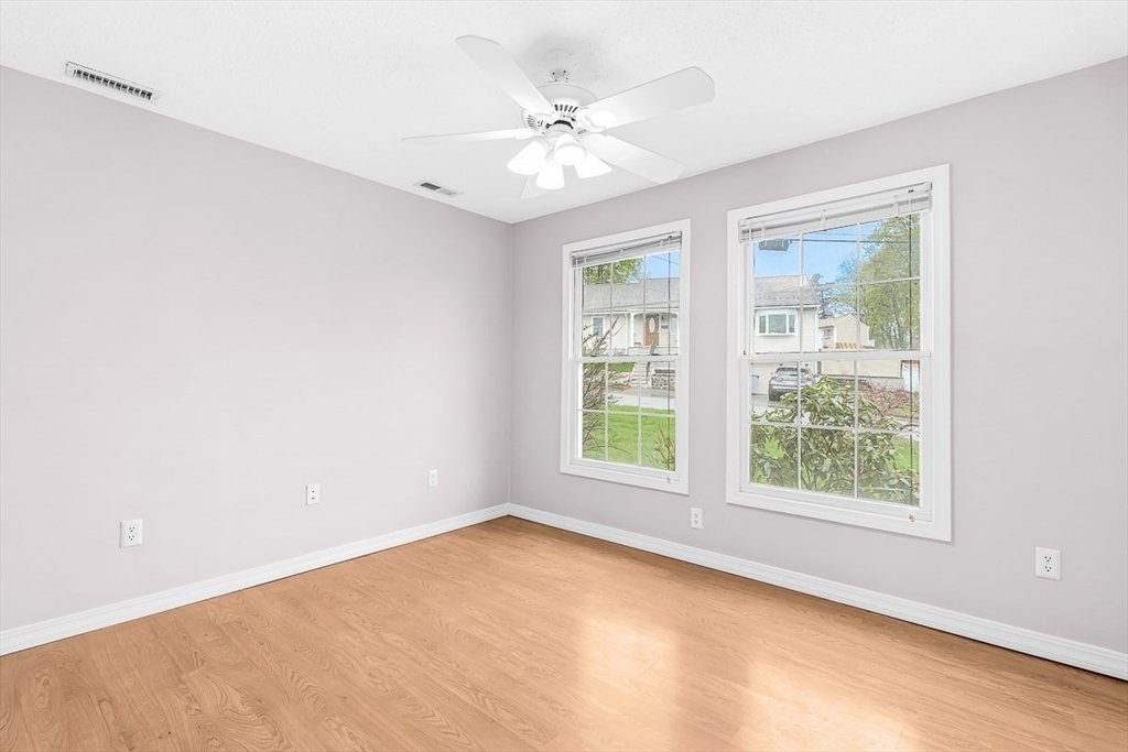 3 Theresa Road Stoneham, MA 02180 - Photo 27 of 42 an empty room with windows and ceiling fan
