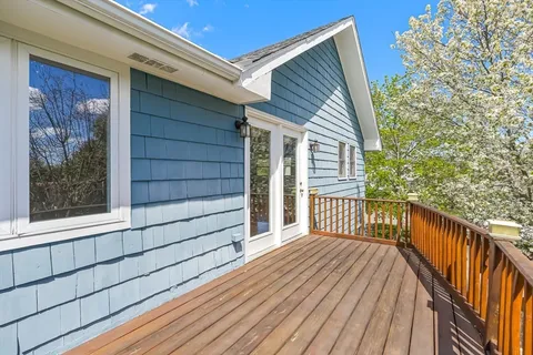 a view of a house with a wooden deck