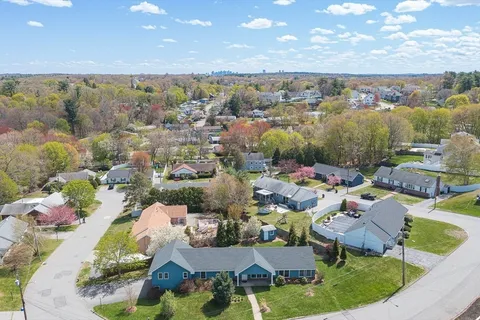 an aerial view of a house with garden space and street view